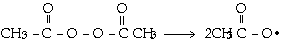 Chemical reaction showing the decomposition of an organic peroxide. The structure on the left consists of two acetyl groups (CH₃-C=O) connected by a peroxide (-O-O-) bond. The reaction produces two acetoxy (CH₃-C=O-O•) radicals, indicated by a dot next to the oxygen atom on the right side of the equation