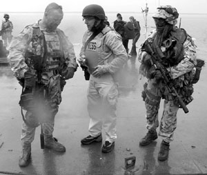 Leiby, flanked by Royal British Marines, at the port of Umm Qsar