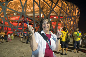 Janet Kolodzy celebrates Olympic spirit in front of the Bird's nest.