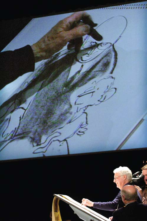 Patrick Oliphant draws cartoons live on stage during the Humor conference.