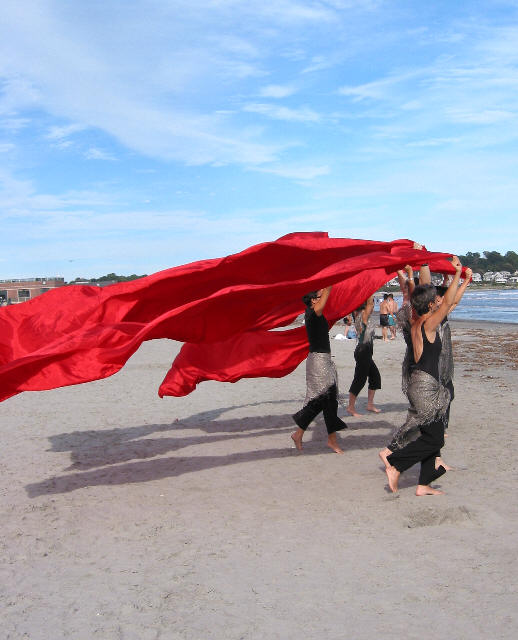 image from sirens beach performance, dancers with red banners